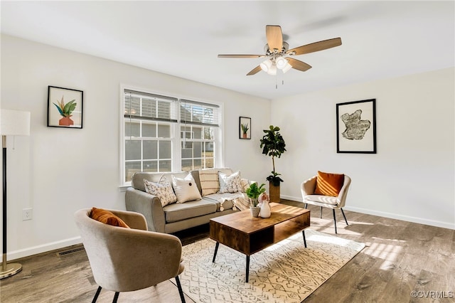 living room featuring wood-type flooring and ceiling fan