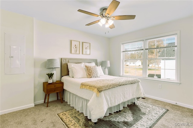 bedroom with carpet, ceiling fan, and electric panel