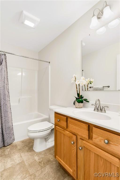 full bathroom featuring vanity, toilet, and shower / bathtub combination with curtain