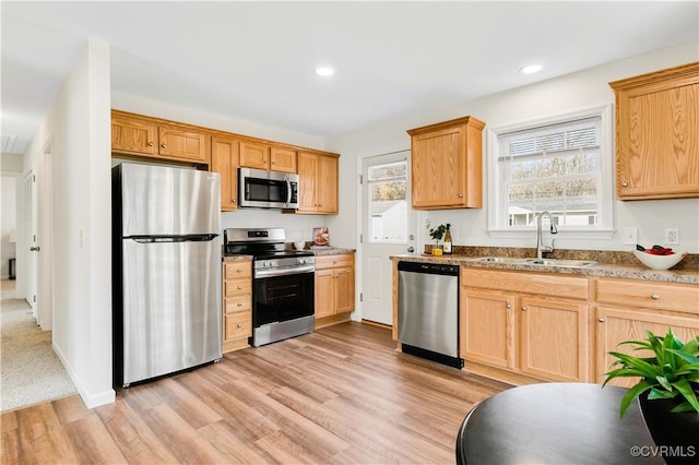 kitchen featuring sink, light wood-type flooring, stainless steel appliances, and light brown cabinetry