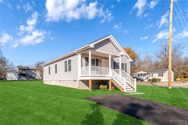 view of front of house with a porch and a front lawn