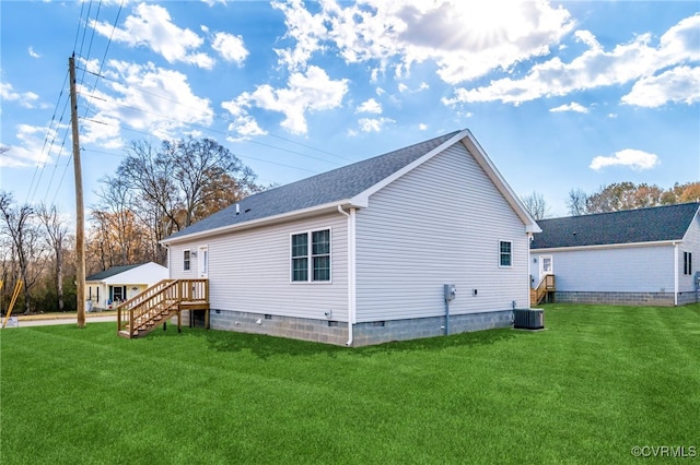 rear view of house with a lawn and cooling unit