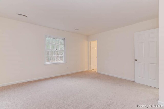 unfurnished room with light carpet