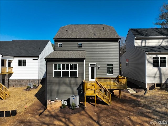 rear view of property with a wooden deck and central AC unit