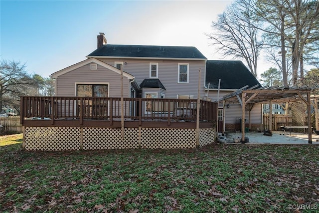 back of house with a pergola, a wooden deck, and a patio area