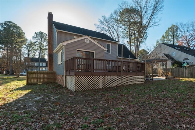 back of property featuring a gazebo and a deck