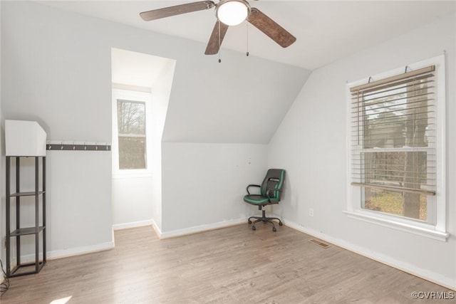 additional living space with plenty of natural light, light hardwood / wood-style floors, and lofted ceiling