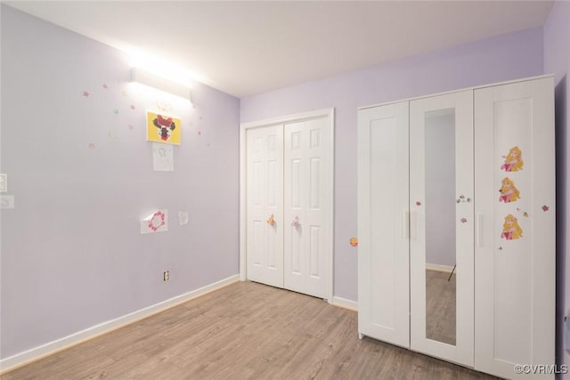 unfurnished bedroom with light wood-type flooring