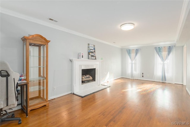 unfurnished living room featuring light hardwood / wood-style flooring and crown molding