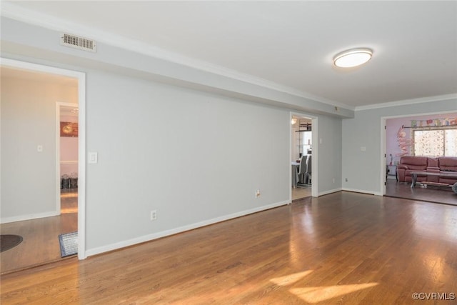 unfurnished living room with wood-type flooring and ornamental molding