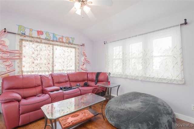 living room featuring ceiling fan, wood-type flooring, and vaulted ceiling