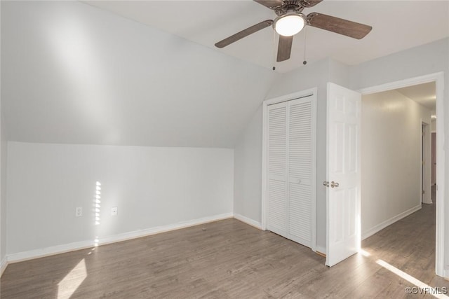 additional living space featuring hardwood / wood-style flooring, ceiling fan, and lofted ceiling