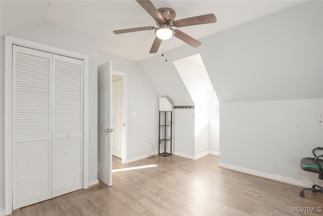 bonus room with lofted ceiling, ceiling fan, and light wood-type flooring