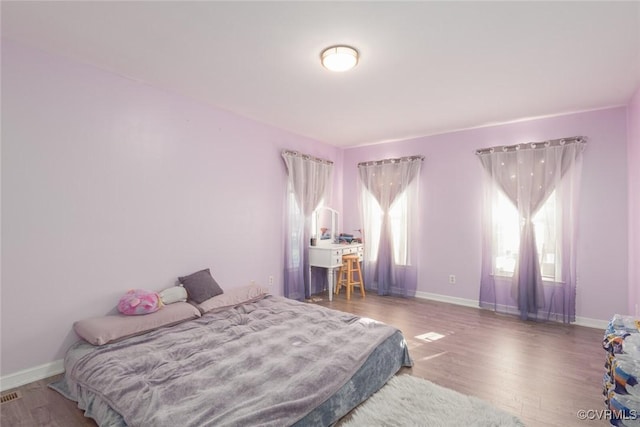 bedroom with hardwood / wood-style floors