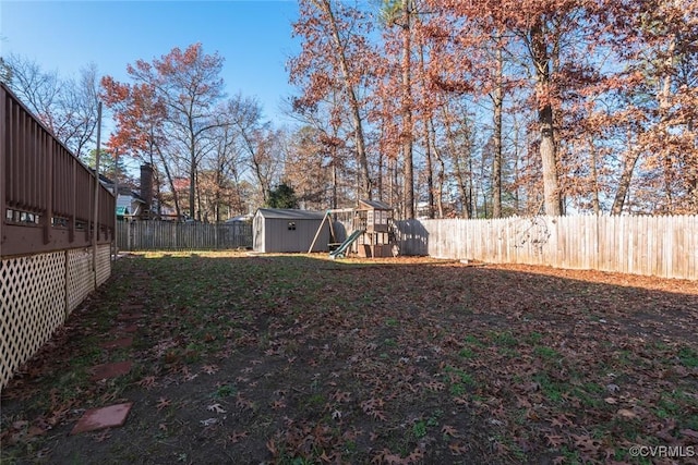 view of yard with a shed and a playground