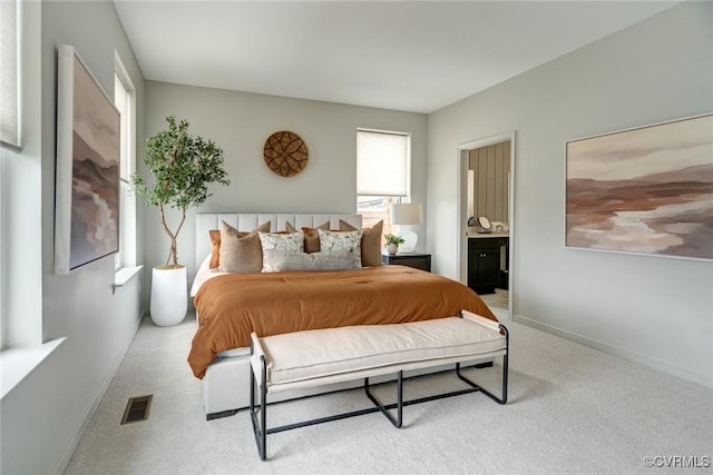 carpeted bedroom featuring connected bathroom