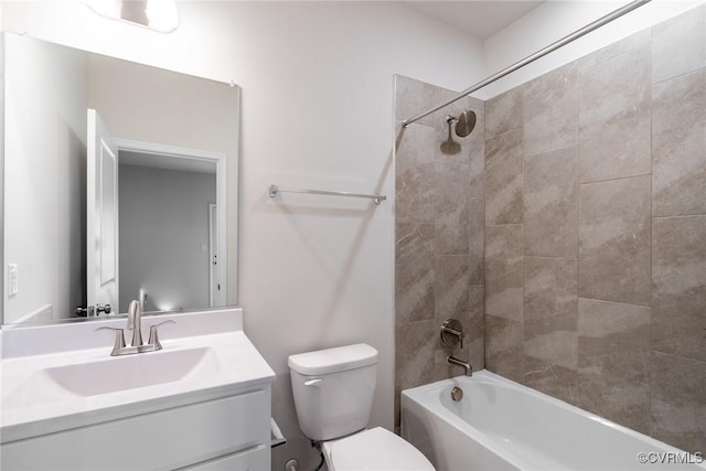 full bathroom with toilet, vanity, and tiled shower / bath