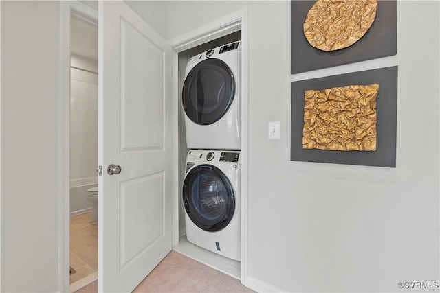 washroom with light colored carpet and stacked washing maching and dryer