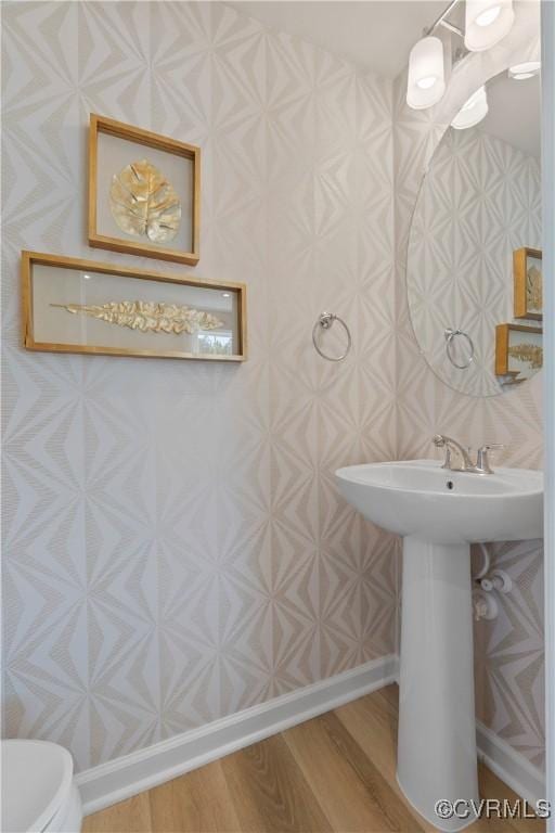 bathroom with toilet and hardwood / wood-style flooring