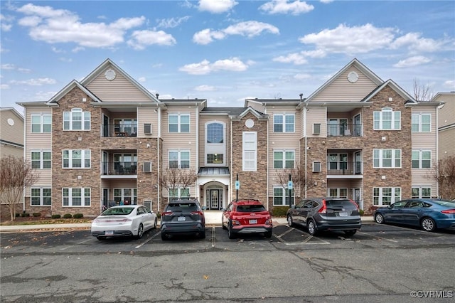 view of property featuring uncovered parking