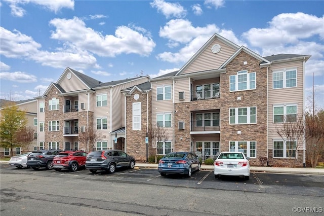 view of property featuring uncovered parking