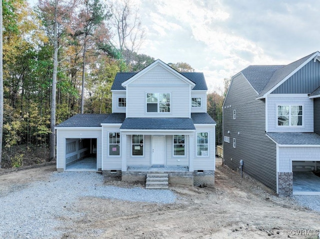 view of front facade featuring covered porch and a garage