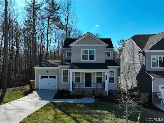 view of front of property featuring a porch, a garage, and a front lawn