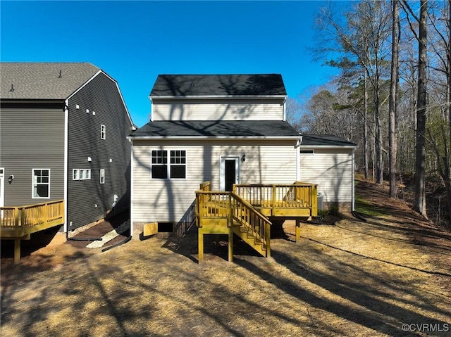 rear view of property featuring a wooden deck