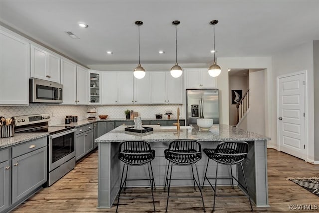2013 Farmstead Mill Ct, Glen Allen, VA 23059 - kitchen featuring appliances with stainless steel finishes, gray cabinetry, a sink, decorative backsplash, and light stone countertops