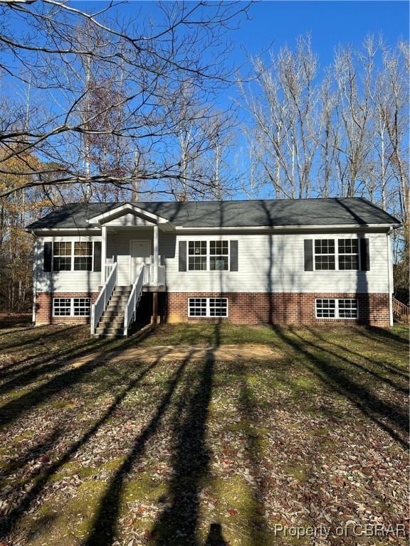 rear view of house with a yard