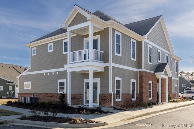 view of front of home with a balcony and central AC unit