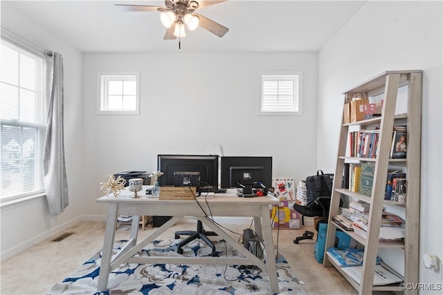 carpeted home office with ceiling fan