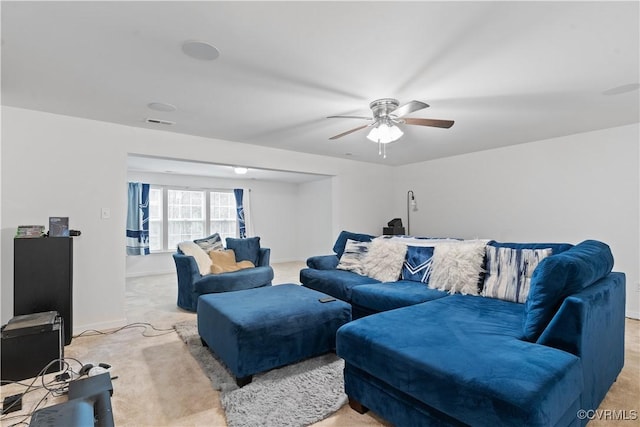 carpeted living room with ceiling fan