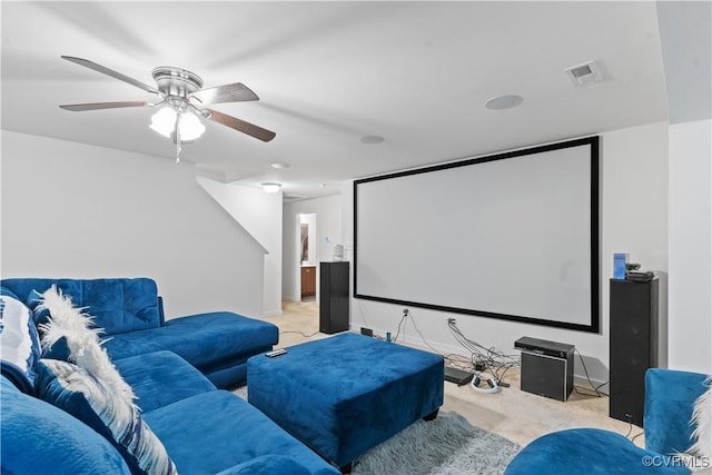 carpeted cinema room with ceiling fan