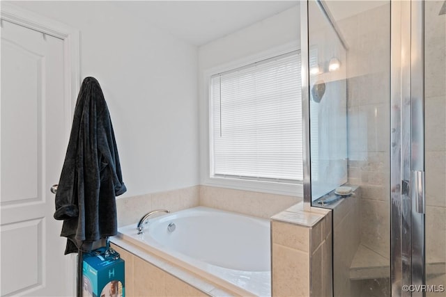 bathroom featuring separate shower and tub and a healthy amount of sunlight