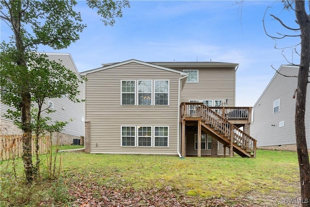 back of house with a wooden deck and a lawn