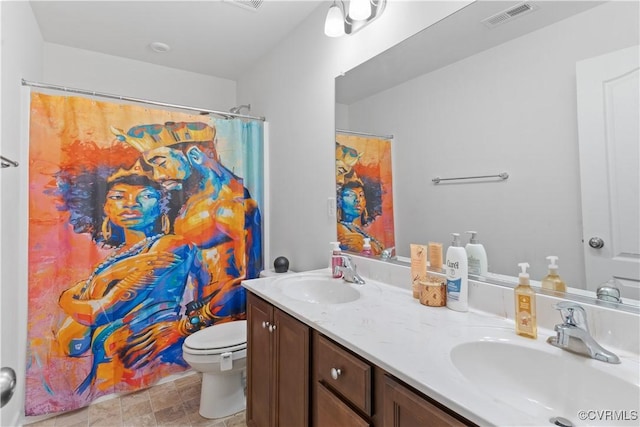 bathroom with vanity, curtained shower, and toilet