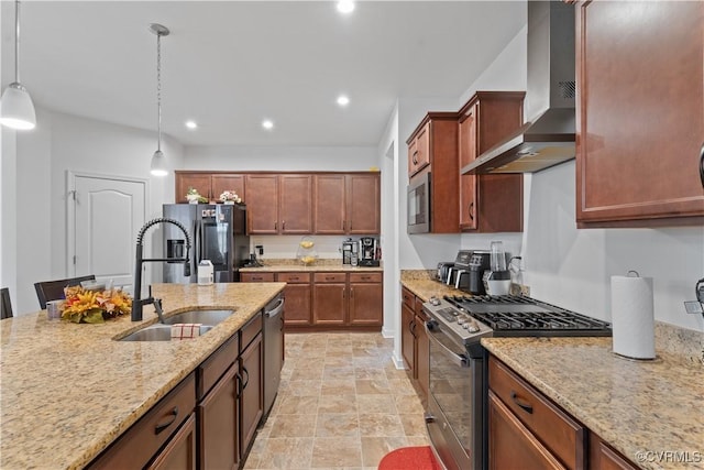 kitchen featuring sink, stainless steel appliances, wall chimney range hood, light stone counters, and pendant lighting