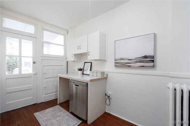 kitchen featuring radiator, dark wood-type flooring, white cabinets, and stainless steel dishwasher