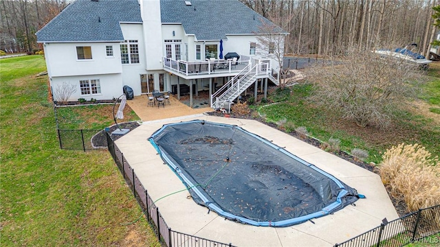 view of swimming pool featuring a yard, a patio, and a wooden deck