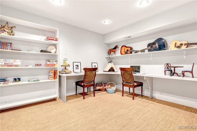 rec room featuring light colored carpet and built in desk