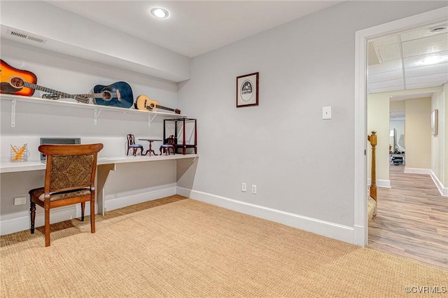 interior space featuring built in desk and light hardwood / wood-style flooring