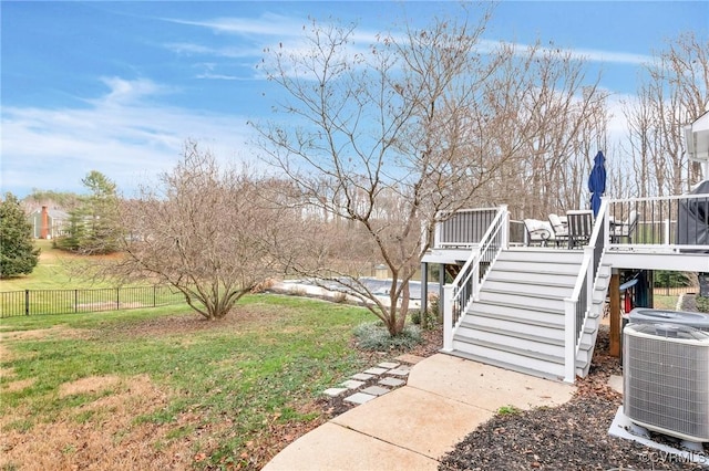 view of yard featuring a deck and central AC