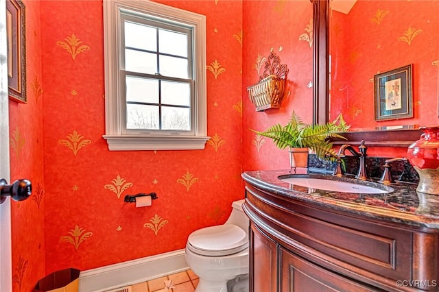 bathroom featuring tile patterned flooring, vanity, and toilet