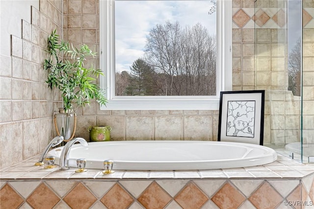 bathroom with tiled bath and tile walls