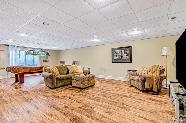 living room featuring light hardwood / wood-style floors, a drop ceiling, and billiards