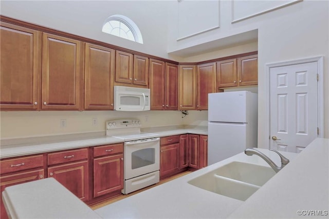 kitchen featuring white appliances and sink