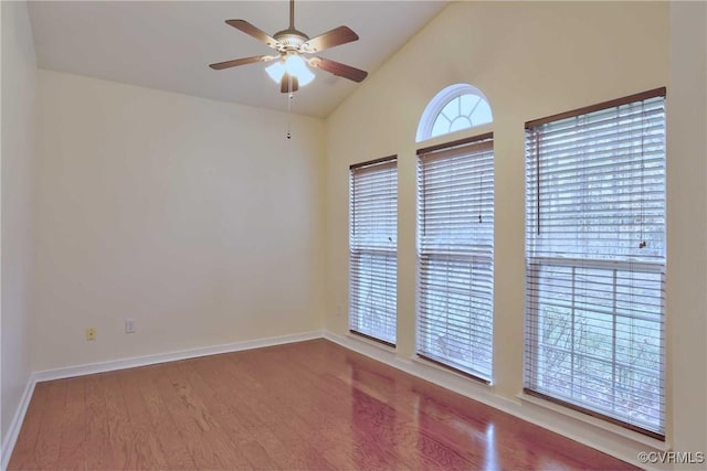 spare room featuring ceiling fan, wood-type flooring, and vaulted ceiling