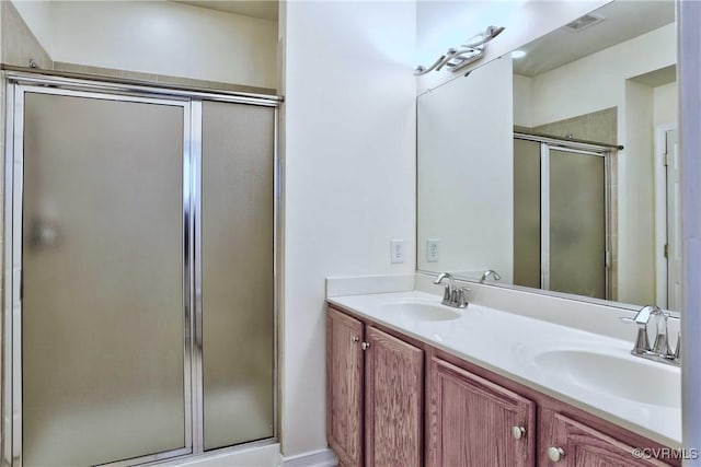 bathroom with vanity and an enclosed shower