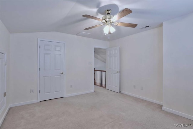 interior space featuring ceiling fan, light carpet, and vaulted ceiling